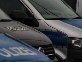 a row of police vans parked next to each other