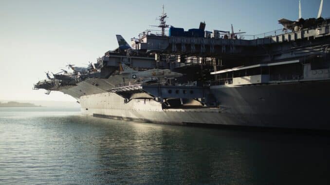 gray warship on body of water