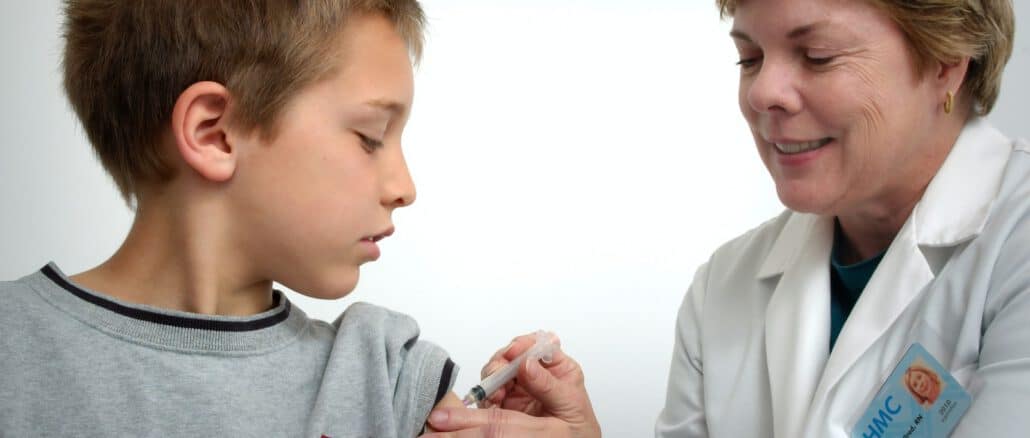 woman inject boy on arm