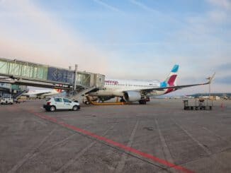 white and blue passenger plane on airport during daytime