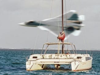 person in red shirt and white shorts sitting on white boat during daytime