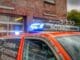 an orange police car parked in front of a building