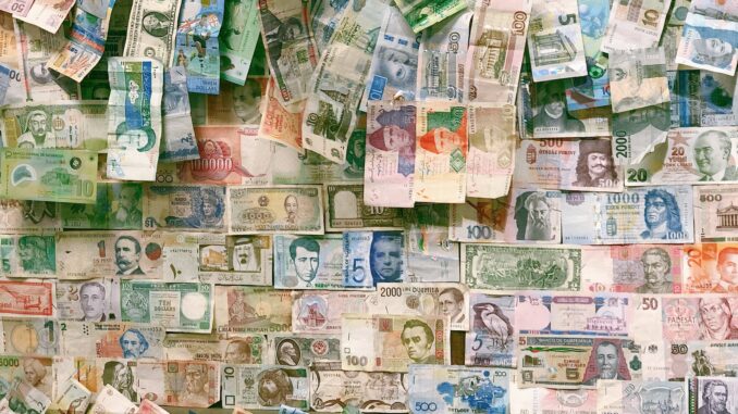 10 and 10 banknotes on brown wooden table