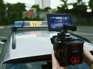person holding black video camera