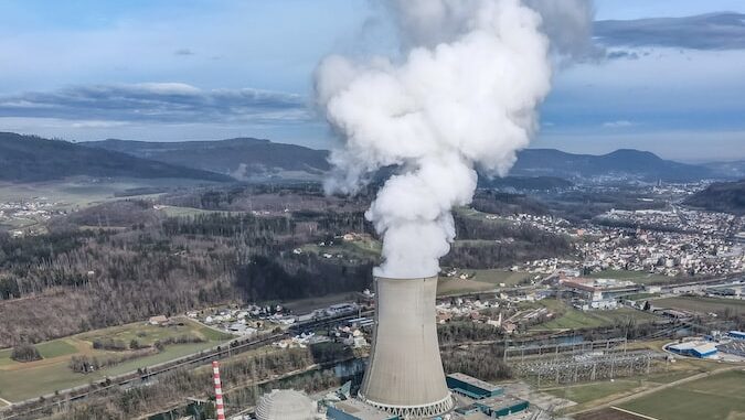 white smoke coming out from green field