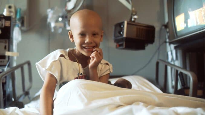 child sitting on bed